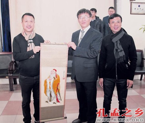 中国侨网张宏明（前排左2）向法国华侨华人会赠送孔子绣像。（法国《欧洲时报》/黄冠杰 摄）